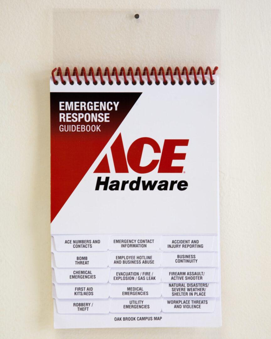 A spiral bound book with the words " ace hardware emergency response guidebook ".