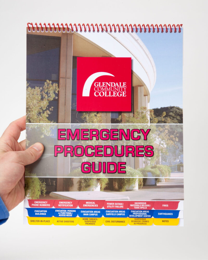 A person holding an emergency procedure guide.