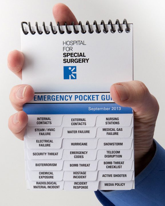 A person holding an emergency pocket guide
